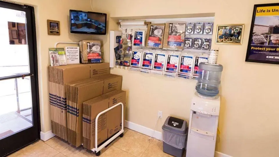 Inside facility office with moving and packing supplies available and a water station